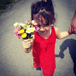 Cute girl holding pink flower