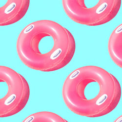 Pattern of small bright pink inflatable rubber circles on a pale blue background