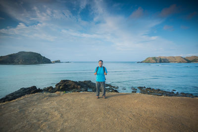 Man standing on beach against sky