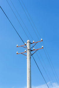 Telephone pole against a blue sky