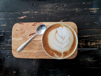 Coffee cup of cappuccino on wooden table