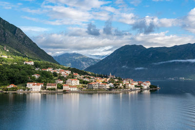 Scenic view of lake by buildings against sky