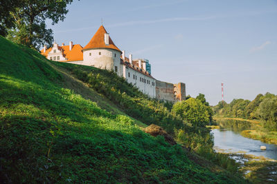 View of castle and buildings against sky