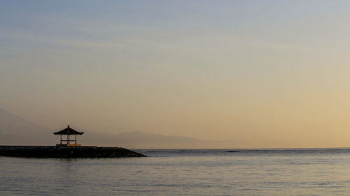 Scenic view of sea against sky at sunset