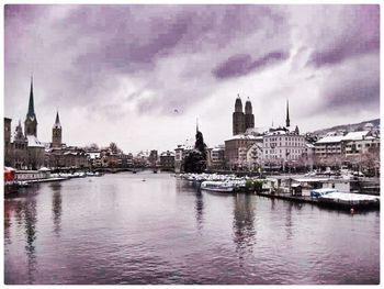 Boats in river with buildings in background