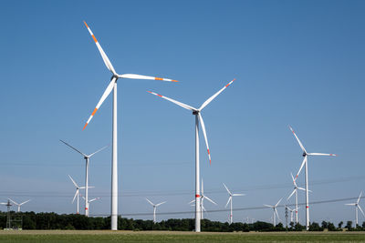 Windmills against blue sky