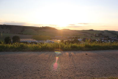 Scenic view of field against sky during sunset