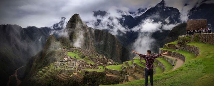 View of waterfall against cloudy sky