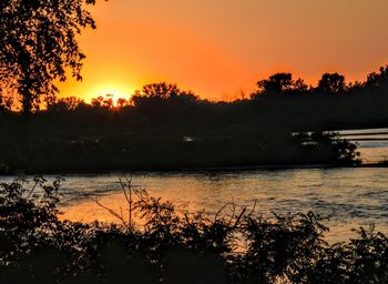 Scenic view of lake against romantic sky at sunset