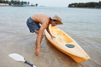 Low section of woman in boat in sea