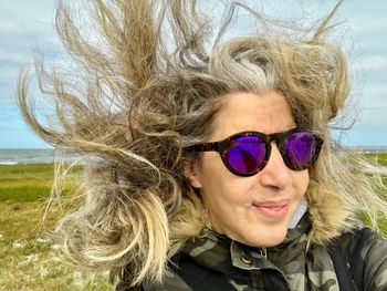 Portrait of smiling woman wearing sunglasses