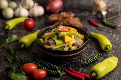 Close-up of tomatoes and vegetables on table