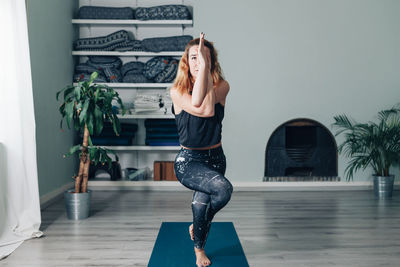 Side view of woman exercising in gym