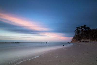 Scenic view of beach against sky during sunset