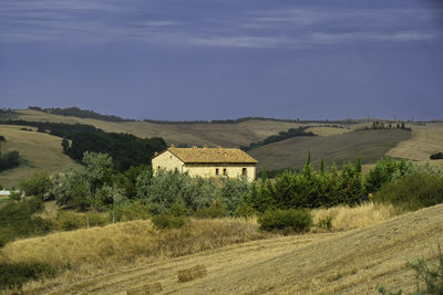 Houses on field against sky