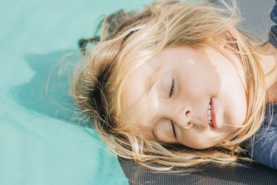 High angle view of cute girl sleeping on floor