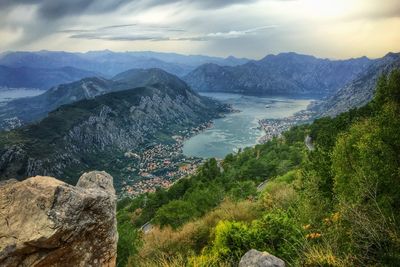 Scenic view mountain range against cloudy sky during sunset