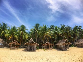 Built structure on beach against blue sky