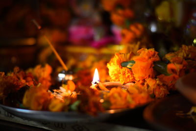 Close-up of burning candles in temple