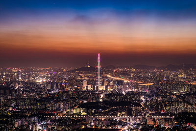 Aerial view of illuminated city buildings at night