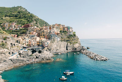 Panoramic view of sea and buildings against sky