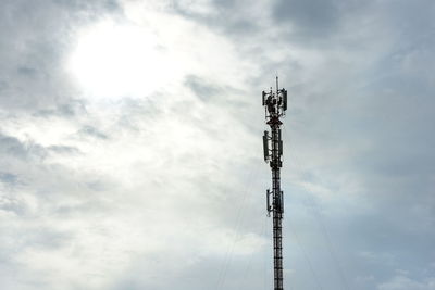 Low angle view of communications tower against sky