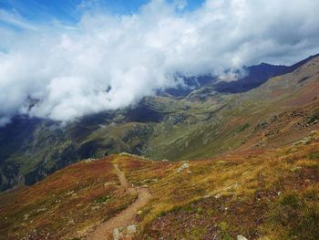 Scenic view of mountains against cloudy sky