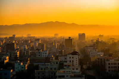 Silhouette buildings against sky during sunset