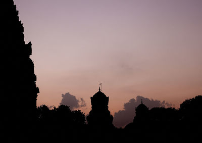 Silhouette built structures at sunset