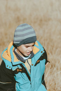 Boy on grassy field during winter