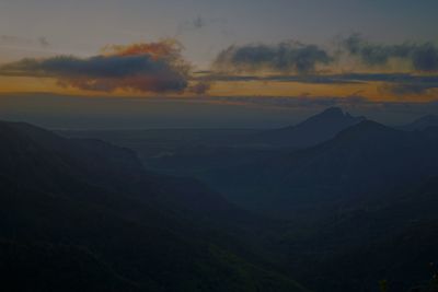 Scenic view of silhouette mountains against sky during sunset