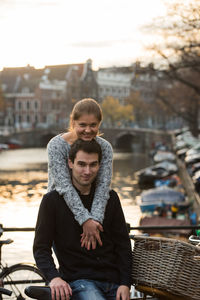Young couple against canal in city