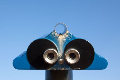 Close-up of coin-operated binoculars against clear sky