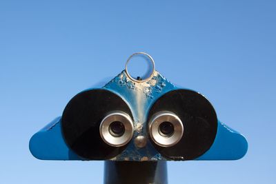 Close-up of coin-operated binoculars against clear sky