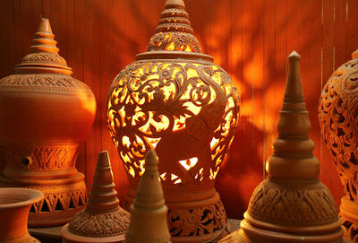 Orange brown unglazed clayware lamp with an intricate patterns of koh kret pottery, thailand