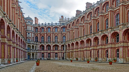 Buildings in town against sky