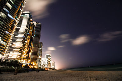 Low angle view of illuminated city at night