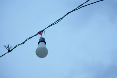 Low angle view of cables against clear blue sky