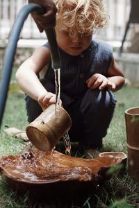 Young boy playing with water