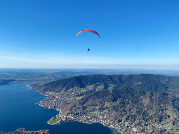 Low angle view of person paragliding against sky