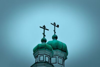 Low angle view of cross against clear blue sky