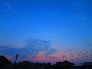 Silhouette roof against sky at sunset