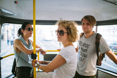 Friends standing in bus