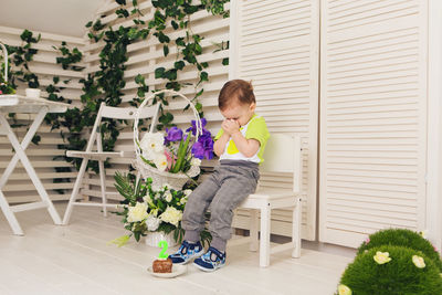 Full length of boy sitting on floor at home