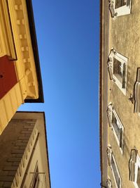 Low angle view of building against clear blue sky