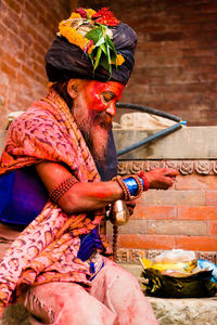 Rear view of man sitting in temple