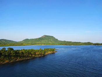 Scenic view of lake against clear blue sky