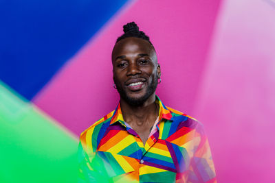 Portrait of smiling man against colored background