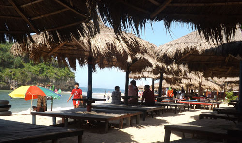 People relaxing in restaurant against sky