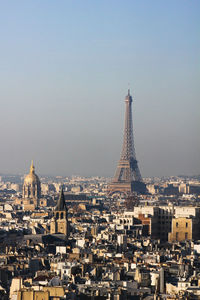 Aerial view of buildings in city against clear sky